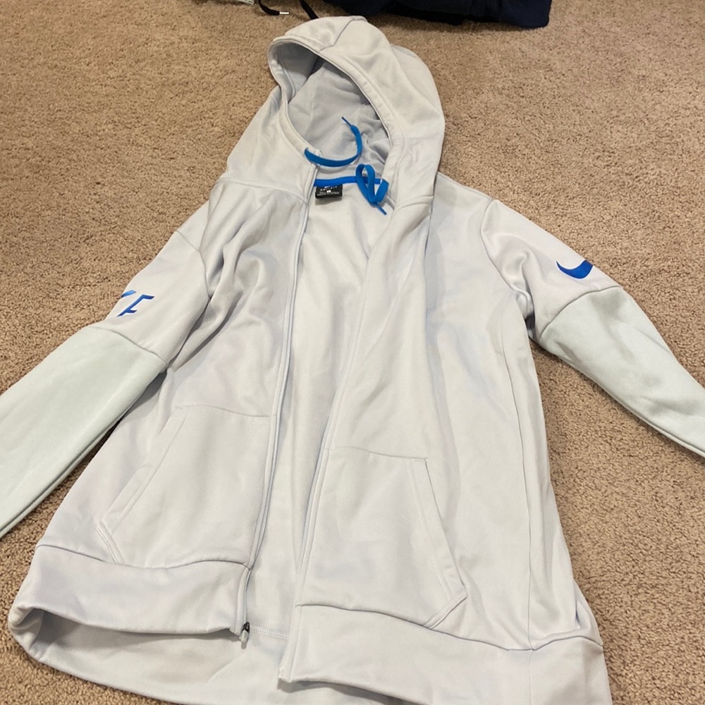 Light grey nike zip up jacket with blue details. Size Large.